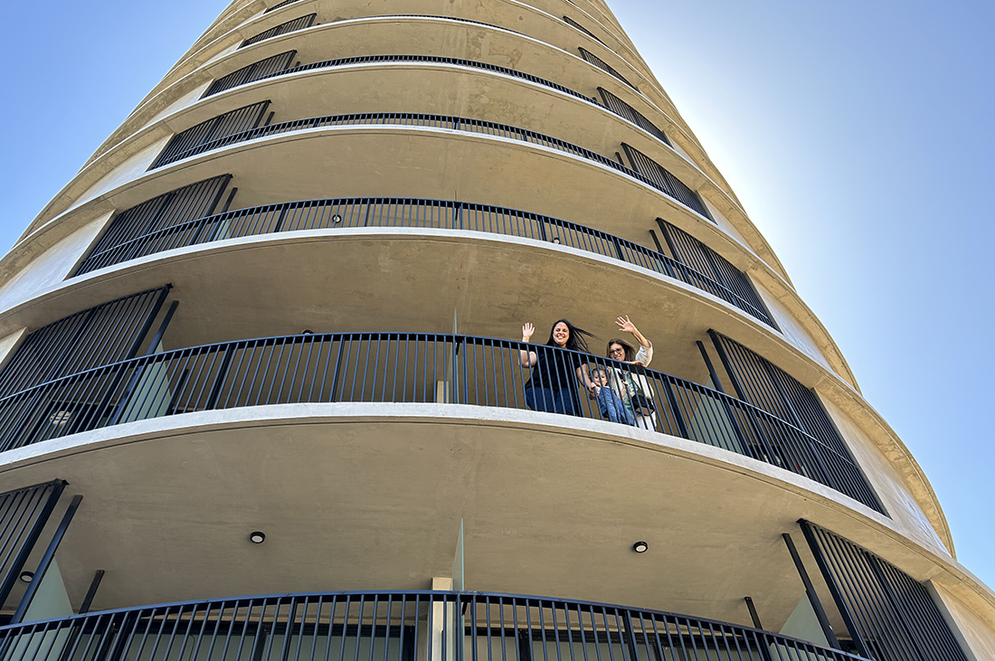 Familia saludando desde el balcón