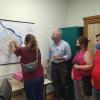 Vecina mostrando un punto en el mapa de San José, junto a Mill, Gianoni y un vecino